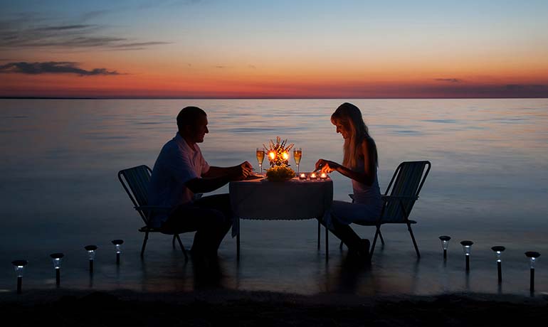 9 Best Romantic Weekend Getaways For Couples Marchay   Young Couple Having Romantic Evening With Candles On Beach 