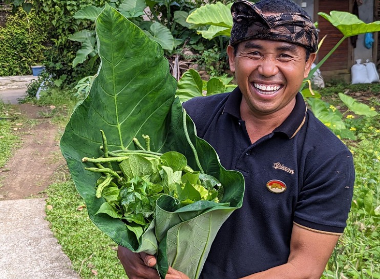 Balinese chef holding vegetables