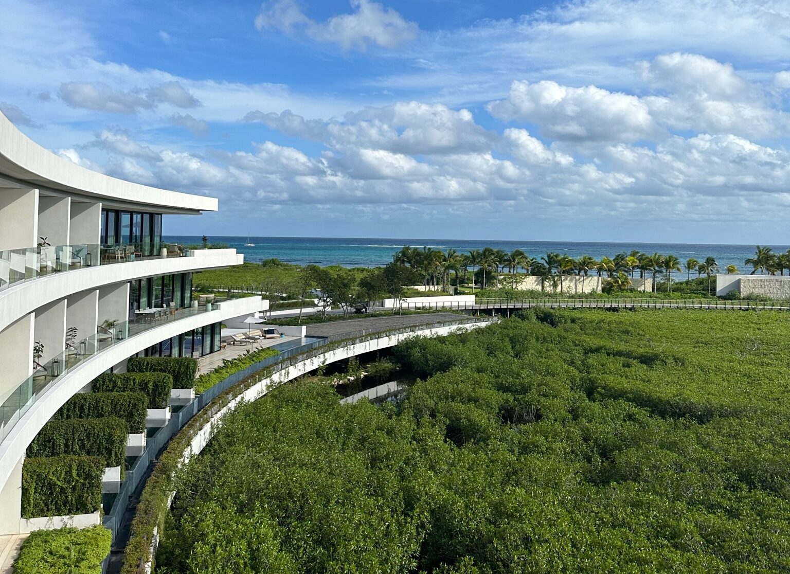 view of hotel, mangroves, and ocean